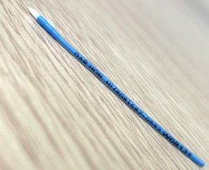 A closeup of a DAR plastic fish tag. If a fish is caught, please call the number listed (808.587.0593)