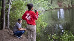 Dofaw staff conducting waterbird surveys for Oʻahu wetlands.