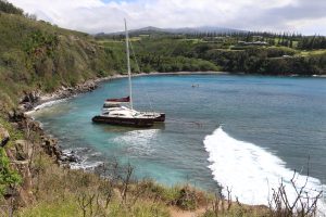 Photo from the cliff top of Maui’s Honolua-Mokulē‘ia Bay taken Mar-14-2025 shows vessel Hula Girl with ropes attached being towed from shore.
