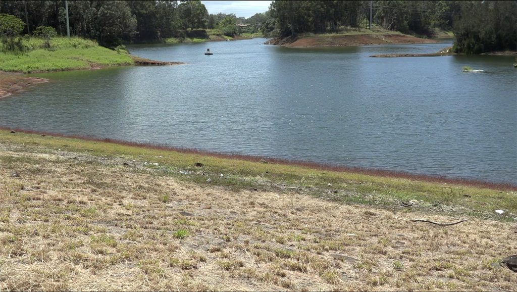 Photo from shore of a buoy floating on Wahiawā Reservoir (also known as Lake Wilson), 05-12-2022.